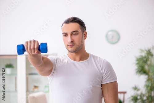 Young male starting day with morning exercises