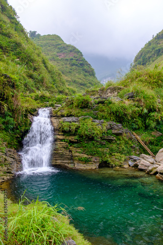The Du Gia waterfall of Ha Giang in northern Vietnam is seen with lush green vegetation at the end of the harvest season