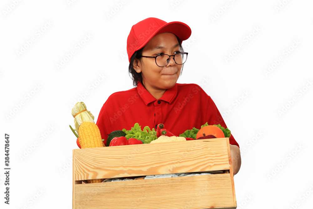 A girl with red uniform deliver fresh vegetable , variouse fresh vegettable in wooden basket carry A girl with red uniform deliver fresh vegetable , variouse fresh vegettable in wooden basket carry