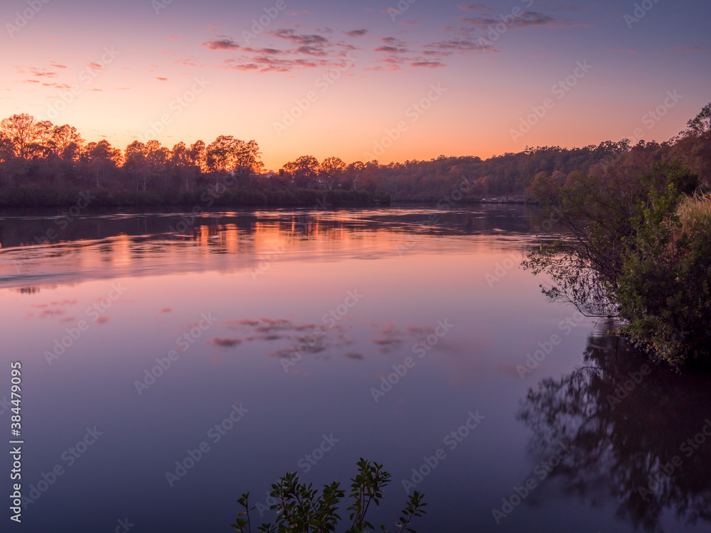 Beautiful Riverside Sunrise with Cloud Reflections