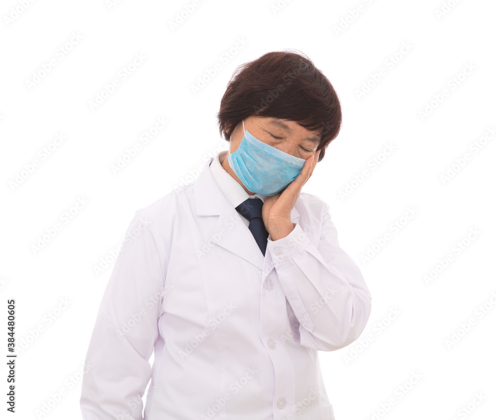 Tired female doctor wearing a mask in front of white background