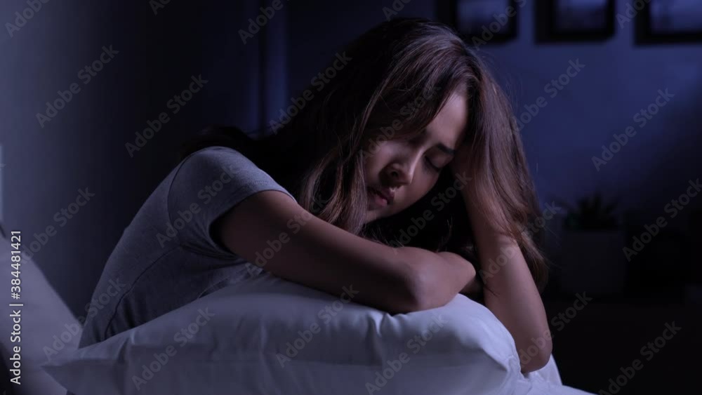 Depressed young Asian woman cannot sleep from insomnia. Depressed woman suffering from insomnia lying in bed. Depressed young Asian woman cannot sleep from insomnia. Depressed woman suffering from insomnia lying in bed.