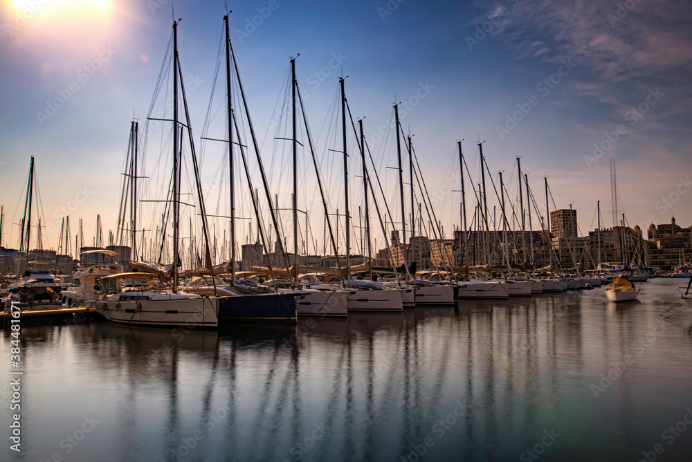 Sailboats in the port of La Canebière with their reflections at sunset - Marseille - France - June 2019