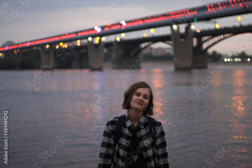 Portrait of a young woman in front of the bridge