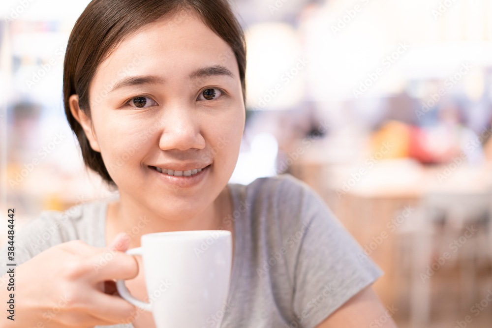 Beautiful Asian woman enjoy drinking a coffee in cafe. Beautiful Asian woman enjoy drinking a coffee in cafe.