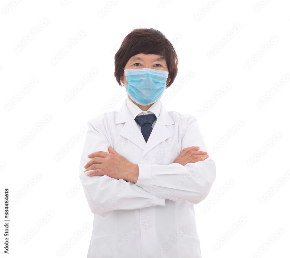 Female doctor holding arms wearing mask standing in front of white background Female doctor holding arms wearing mask standing in front of white background