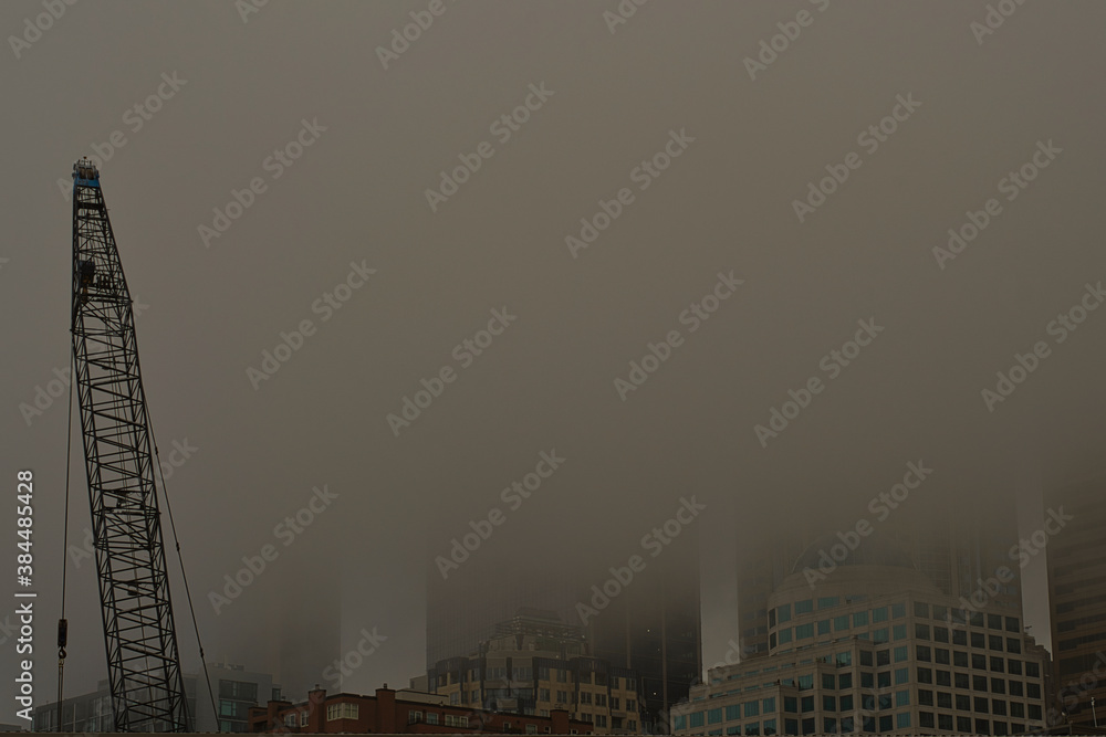 Fototapeta premium 2020-10-10 DOWNTOWN SEATTLE SKYLINE IN FOG WITH A CRANE IN THE FOREGROUND