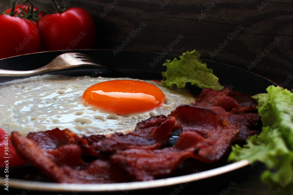 Fried eggs, omelet traditional rustic breakfast, fried eggs, roasted bacon, sausage for breakfast . Healthy food Fried eggs, omelet traditional rustic breakfast, fried eggs, roasted bacon, sausage for breakfast . Healthy food
