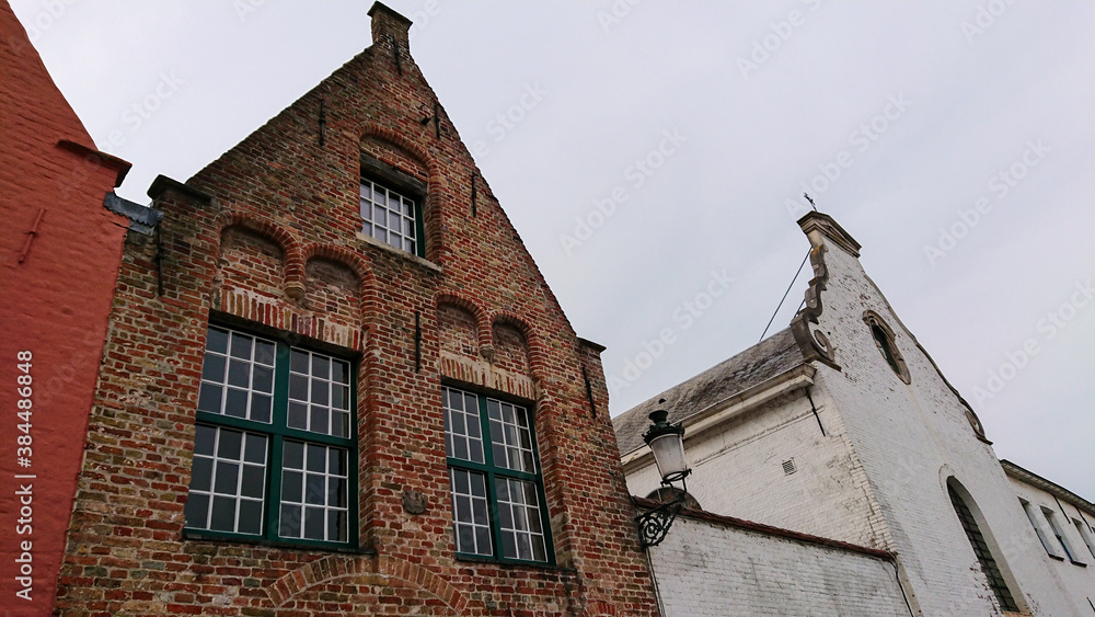 Roofs And Windows Of Old Authentic Brick Houses And Church In Bruges, Belgium Roofs And Windows Of Old Authentic Brick Houses And Church In Bruges, Belgium
