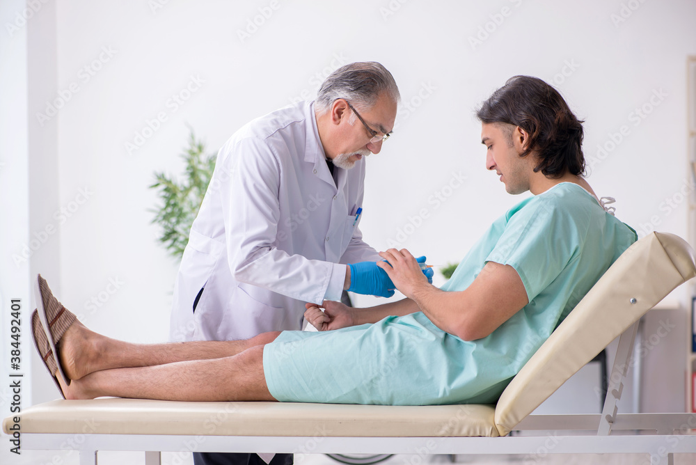 Fototapeta premium Young male patient visiting experienced doctor