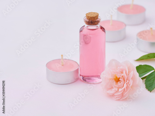 Aromatherapy oil bottle and pink rose