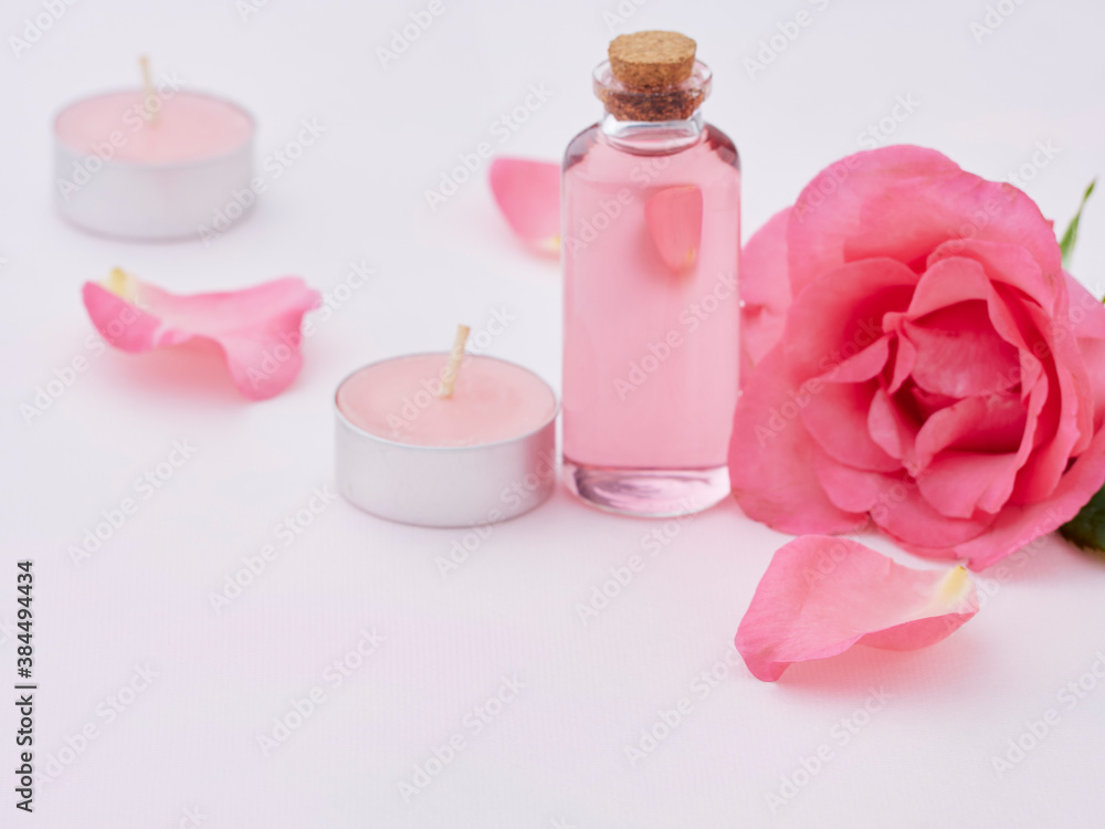 Aromatherapy oil bottle and pink rose Aromatherapy oil bottle and pink rose