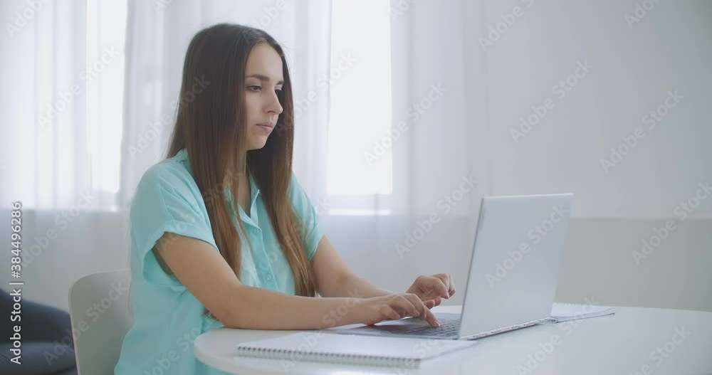 Businesswoman With Laptop In Her Office At The Desk, Working. Business woman works on laptop on background of panoramic windows Businesswoman With Laptop In Her Office At The Desk, Working. Business woman works on laptop on background of panoramic windows