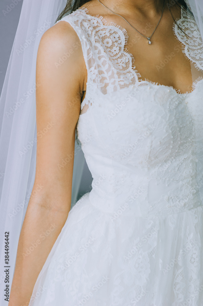 Details of a wedding dress. Close up of faceless girl in beautiful white wedding dress.