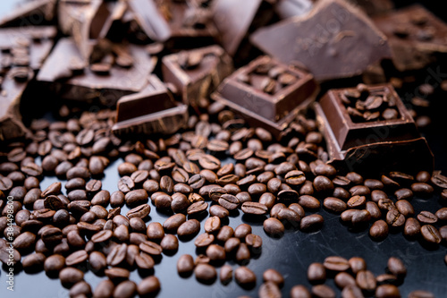 dark organic chocolate and coffee beans on concrete background