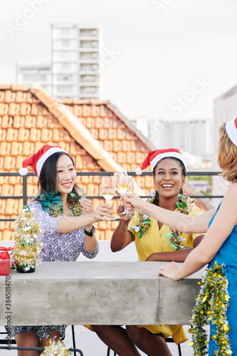 Wallpaper Mural Group of multi-ethnic young women celebrating Christmas and toasting with glasses of champagne Torontodigital.ca