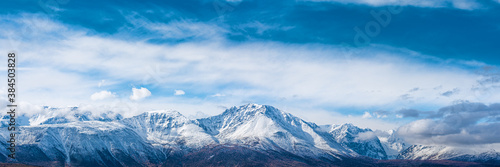 panoramic view of picturesque snowy mountains tops on blue sky background © photollurg