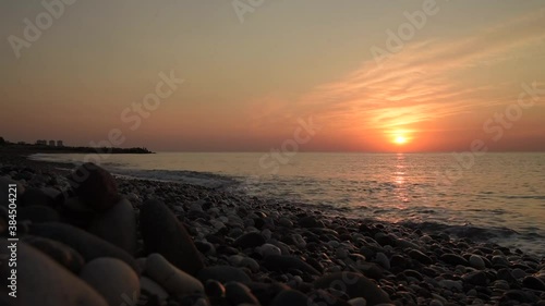 Amazing sunrise over the beach. Yellow golden sun over sea. Orange colors waves. Nature background. Beautiful scene. Morning. Sunlight reflect on water surface