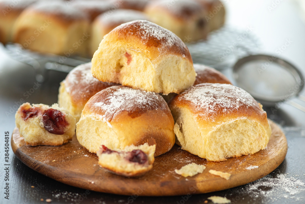 Sweet bread rolls with cherri filling and powdered sugar on top