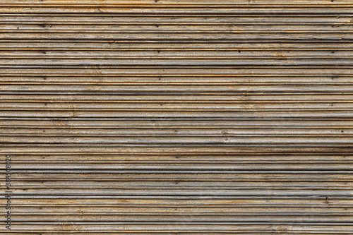 Beautiful horizontal texture of yellow and brown boards with knots and resin is in the photo