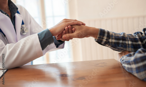 Doctors shake patients' hands to talk, comfort and support cancer patients. The concept of psychiatric treatment. photo