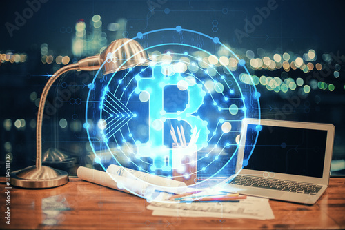 Double exposure of blockchain theme hologram and table with computer background. Concept of bitcoin crypto currency. photo