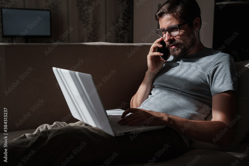 Smiling handsome freelancer working remotely from home. Smiling handsome freelancer working remotely from home.
