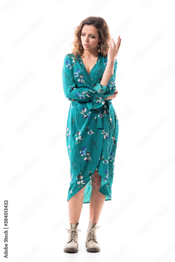 Doubtful displeased young woman looking down gesticulate with hand. Full body portrait isolated on white background Doubtful displeased young woman looking down gesticulate with hand. Full body portrait isolated on white background