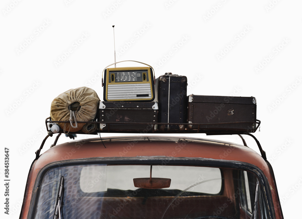 suitcases and radio on roof rack car in retro style isolated on white background