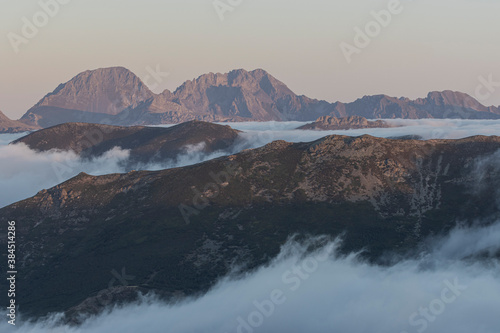 Amazing and cloudy sunrise in the mountains. Cloudscape in Spain. © Inigo Sarralde