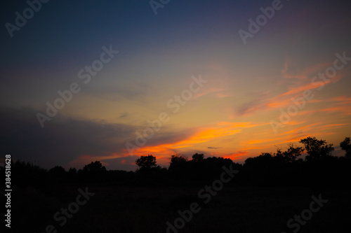 beautiful orange cloudy sunset at the fields 