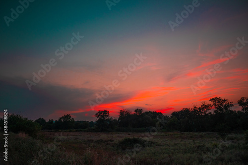 Fototapeta Naklejka Na Ścianę i Meble -  beautiful pink cloudy sunset at the fields 