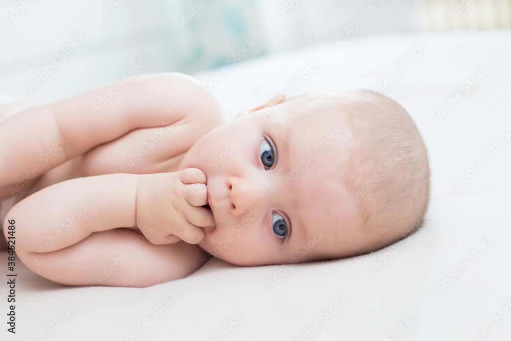 Little baby girl lying with hand in mouth Little baby girl lying with hand in mouth