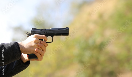 Pistol in man hands background and texture
