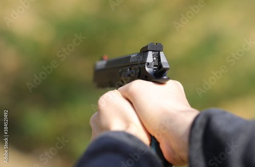 Pistol in man hands background and texture