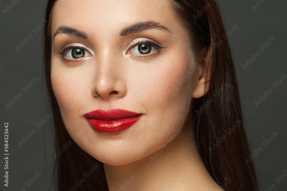 Pretty woman face with perfect makeup close up. Red lips, golden eyeshadow and black eyeliner Pretty woman face with perfect makeup close up. Red lips, golden eyeshadow and black eyeliner