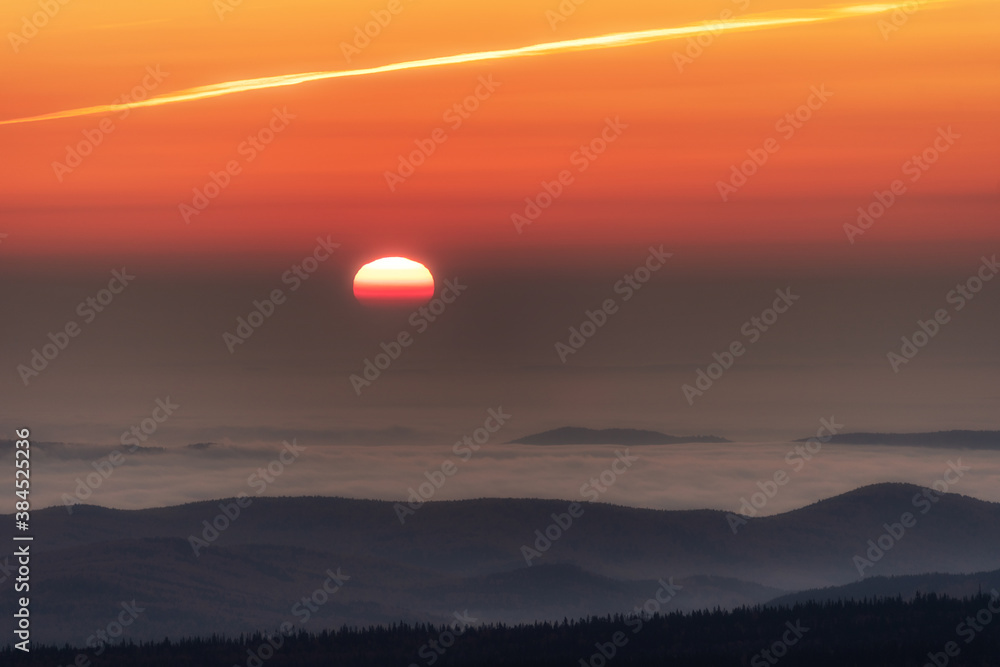 Sunset in the mountains, the sun sets over the horizon