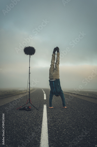 Man handstand on open road with fog in the background. Manfrotto Nanopole with Cinela Albert microphone
