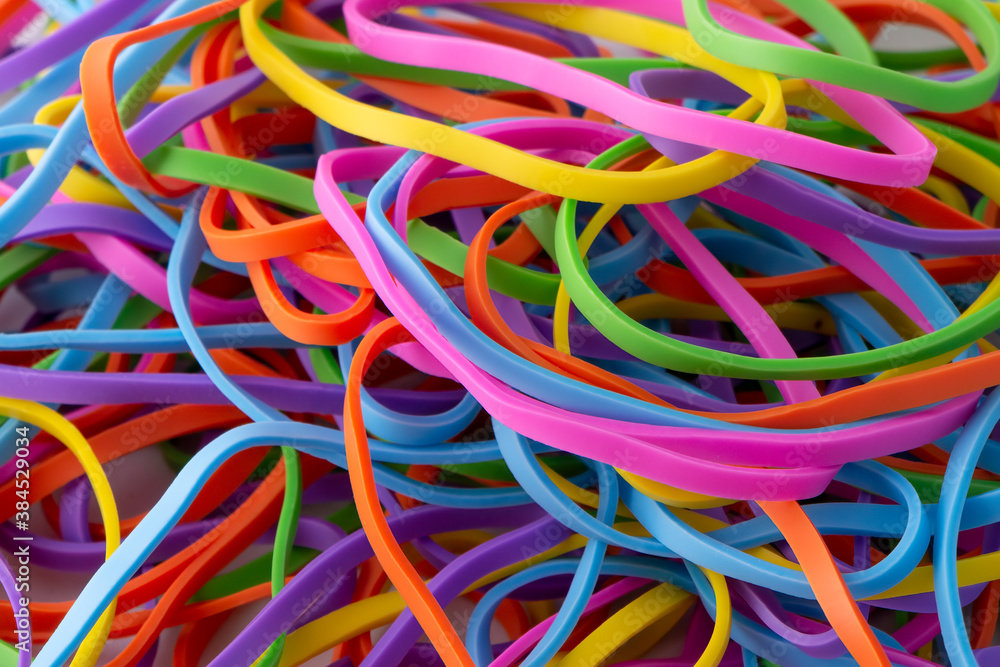 Neon multi colour rainbow rubber bands background texture Neon multi colour rainbow rubber bands background texture