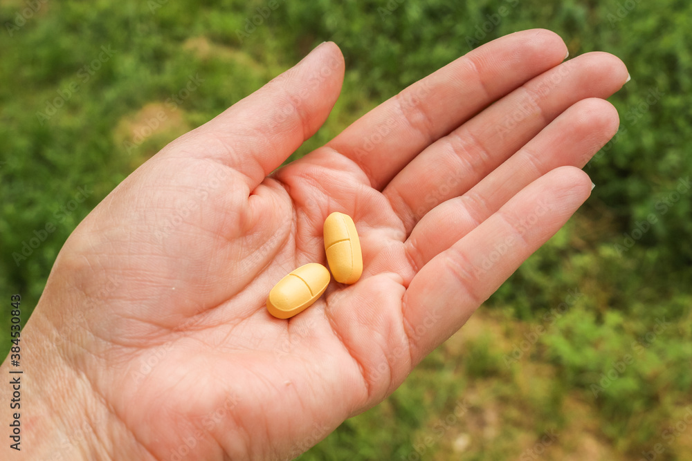 Woman with a handfull of pills, vitamins, or drugs. Woman with a handfull of pills, vitamins, or drugs.