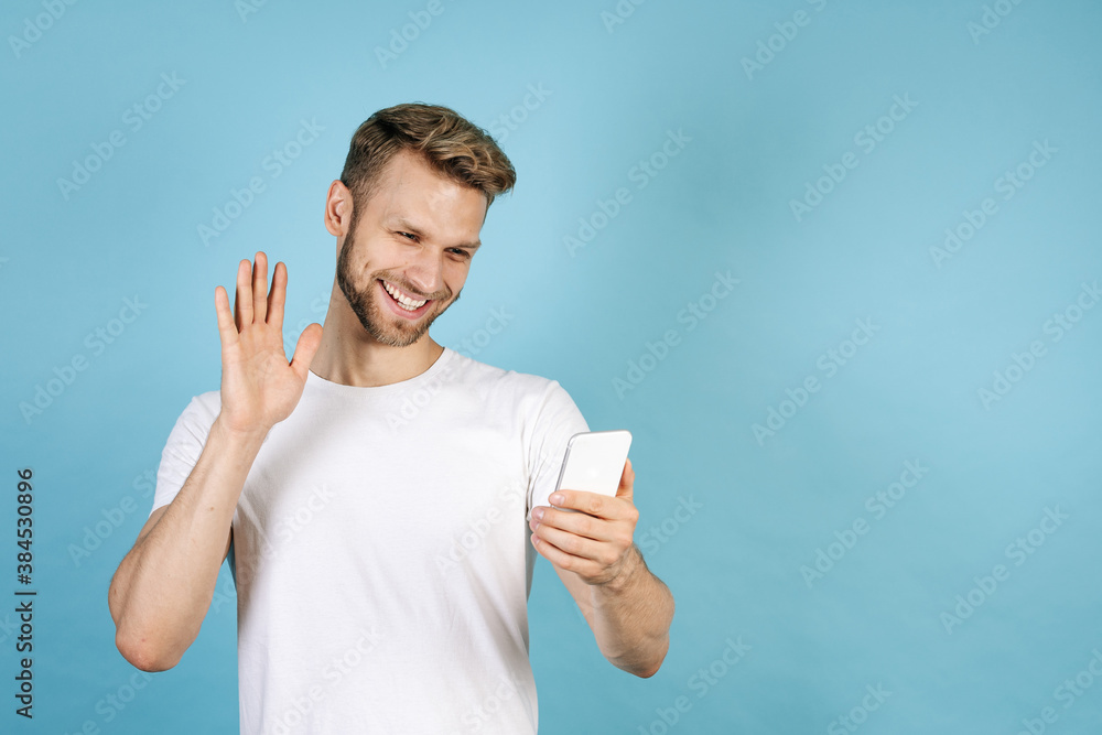 Young adult guy making video call on smartphone Young adult guy making video call on smartphone