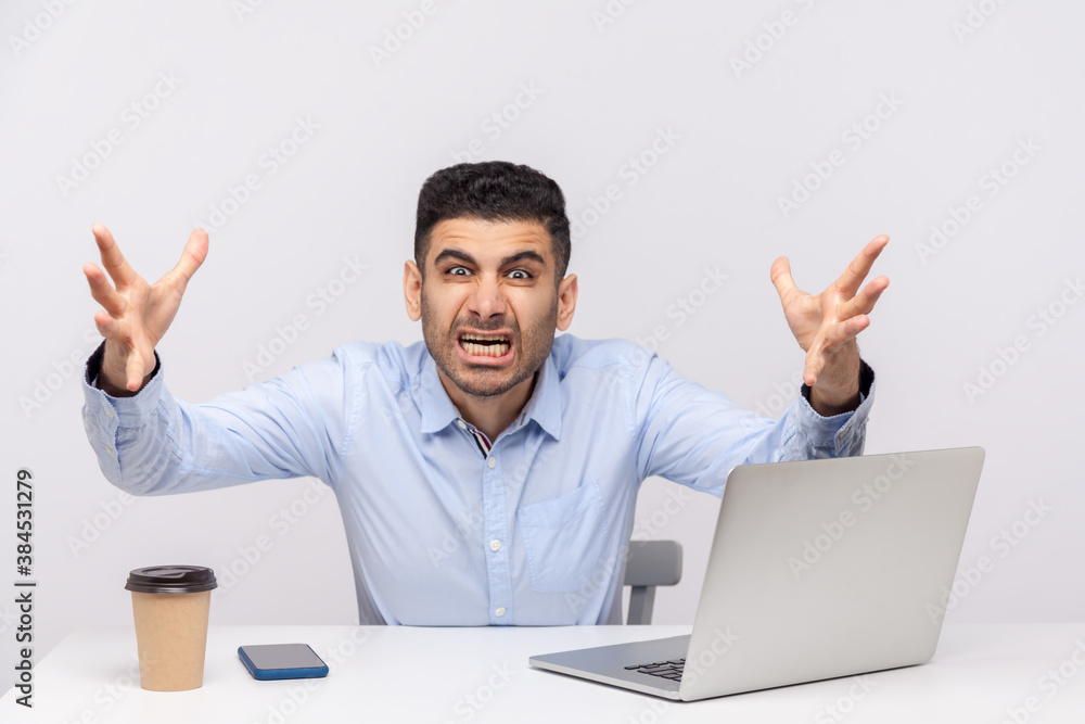 Irritated man boss sitting office workplace, stretching hands to camera, looking furious while shouting with anger, evil crazy grimace, conflict at work. studio shot isolated on white background Irritated man boss sitting office workplace, stretching hands to camera, looking furious while shouting with anger, evil crazy grimace, conflict at work. studio shot isolated on white background