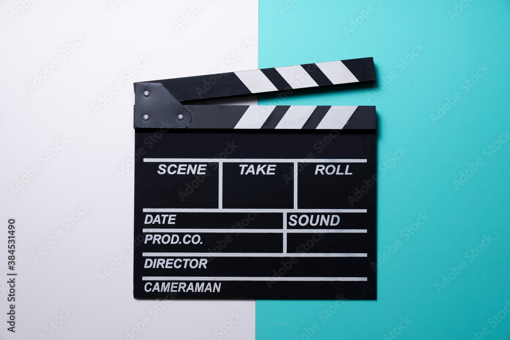 movie clapper on white and green table background ; film, cinema and video photography concept
