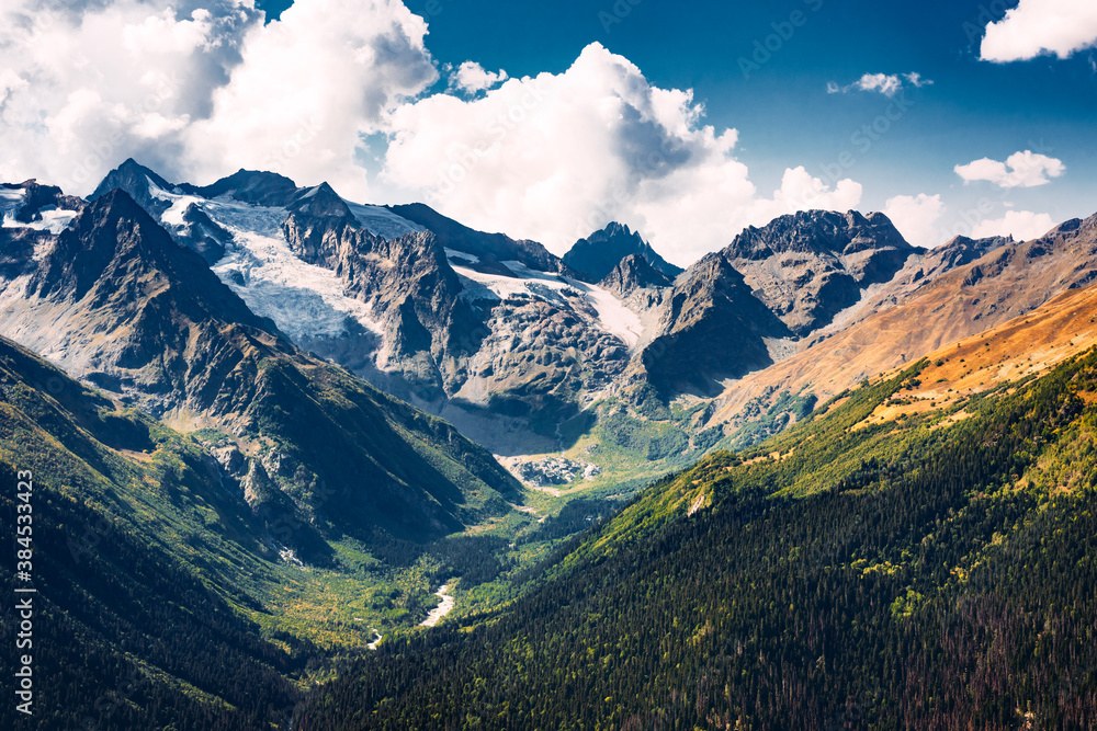 Stunning view of the mountain gorge. Mountain landscape. Beautiful view of the snow-capped mountain peaks. Panoramic view of the glacier. The Caucasus mountain range. Beautiful scenery. Copy space