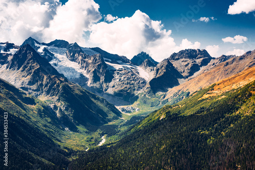 Stunning view of the mountain gorge. Mountain landscape. Beautiful view of the snow-capped mountain peaks. Panoramic view of the glacier. The Caucasus mountain range. Beautiful scenery. Copy space