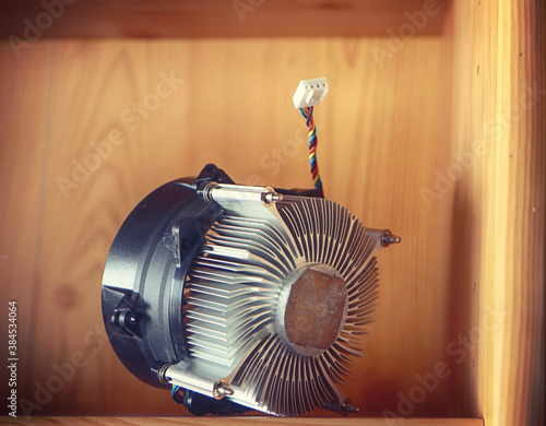 Used computer chipset cooling with fan clipped and passive heatsink in storage on a shelf photo