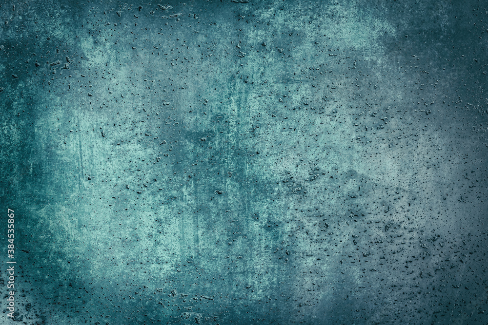 Abstract green or cyan grunge background with scratches. textured surface of stucco wall texture with holes and scuffs