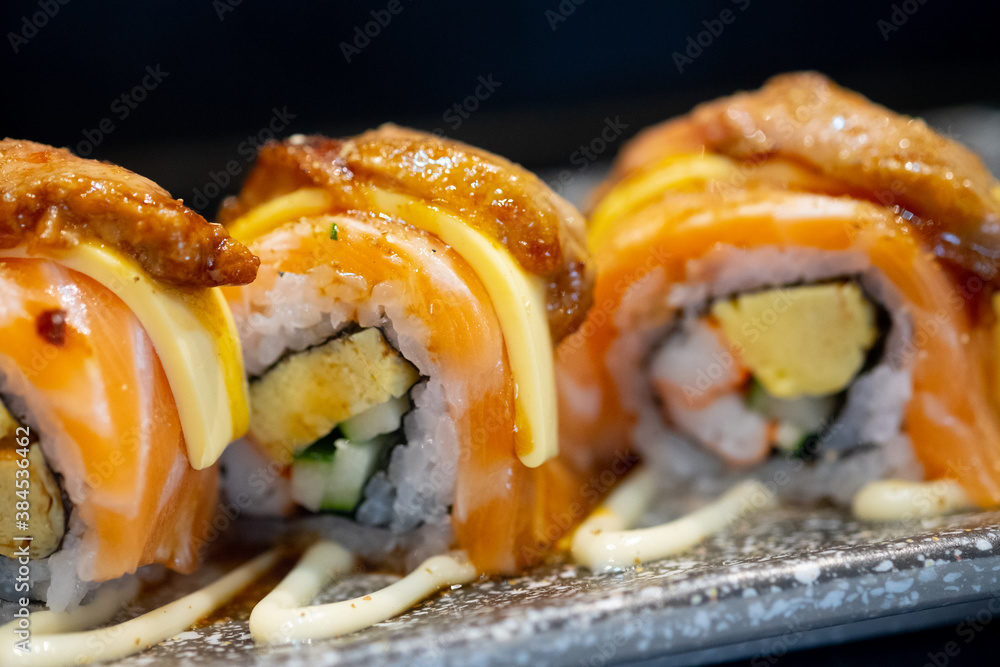 Fresh salmon sushi roll with cheese on top. Japanese food style Fresh salmon sushi roll with cheese on top. Japanese food style