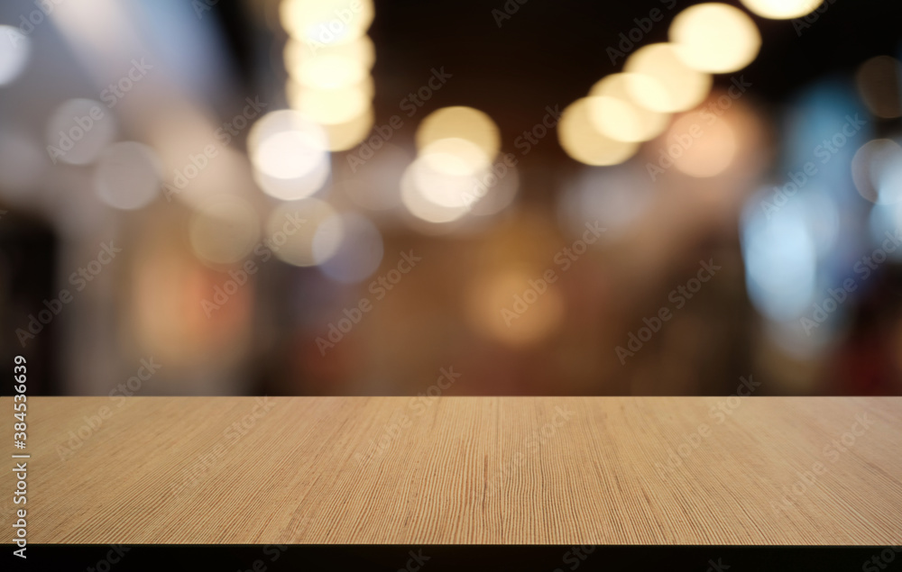 Empty dark wooden table in front of abstract blurred bokeh background of restaurant . can be used for display or montage your products.Mock up for space. Empty dark wooden table in front of abstract blurred bokeh background of restaurant . can be used for display or montage your products.Mock up for space.