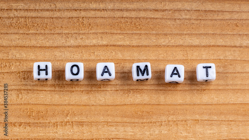 Quadro su tela Close-up of wooden blocks spelling Hoamat meaning home in Bavarian dialect on wood texture